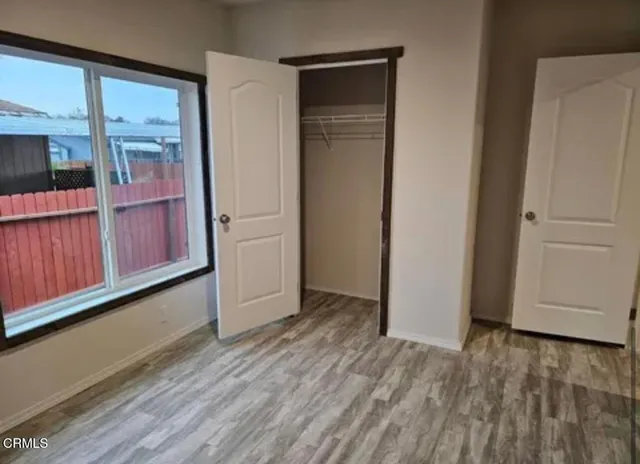 a view of a entrance and room with wooden floor