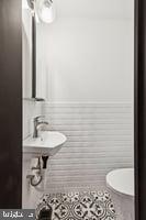 436 Brown Street Philadelphia, PA 19123 - Photo 12 of 62 a bathroom with a sink and a mirror