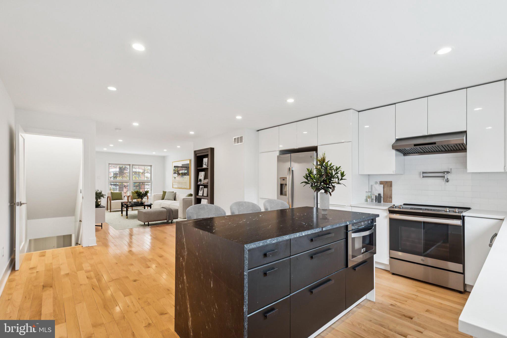 436 Brown Street Philadelphia, PA 19123 - Photo 20 of 62 a kitchen with stainless steel appliances granite countertop a sink stove and refrigerator
