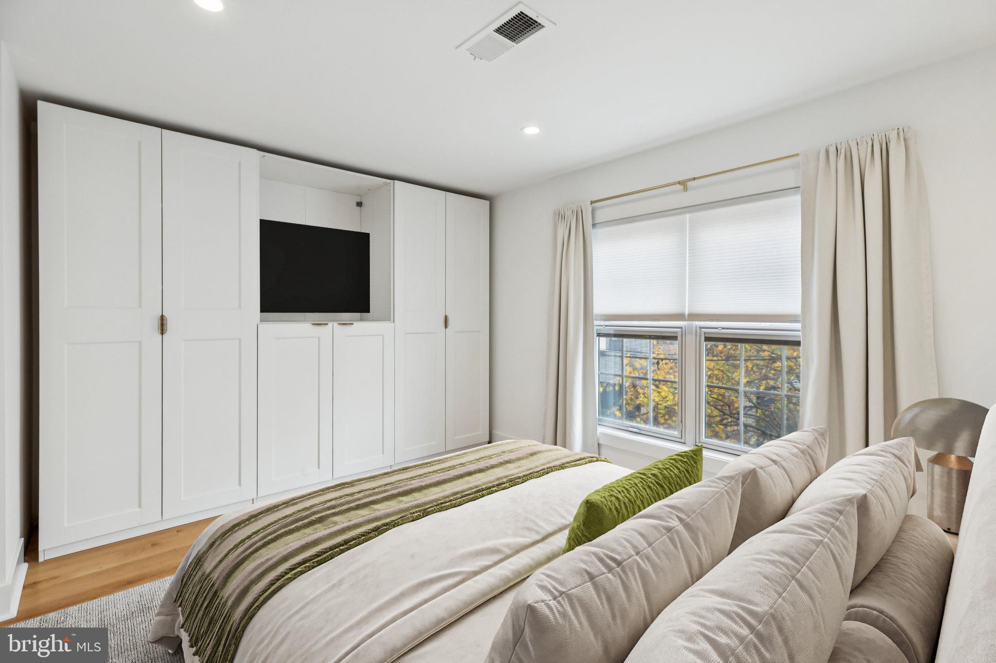 436 Brown Street Philadelphia, PA 19123 - Photo 26 of 62 a bedroom with a bed and a flat screen tv