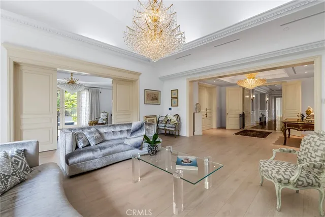 a spacious bedroom with a large bed and a chandelier
