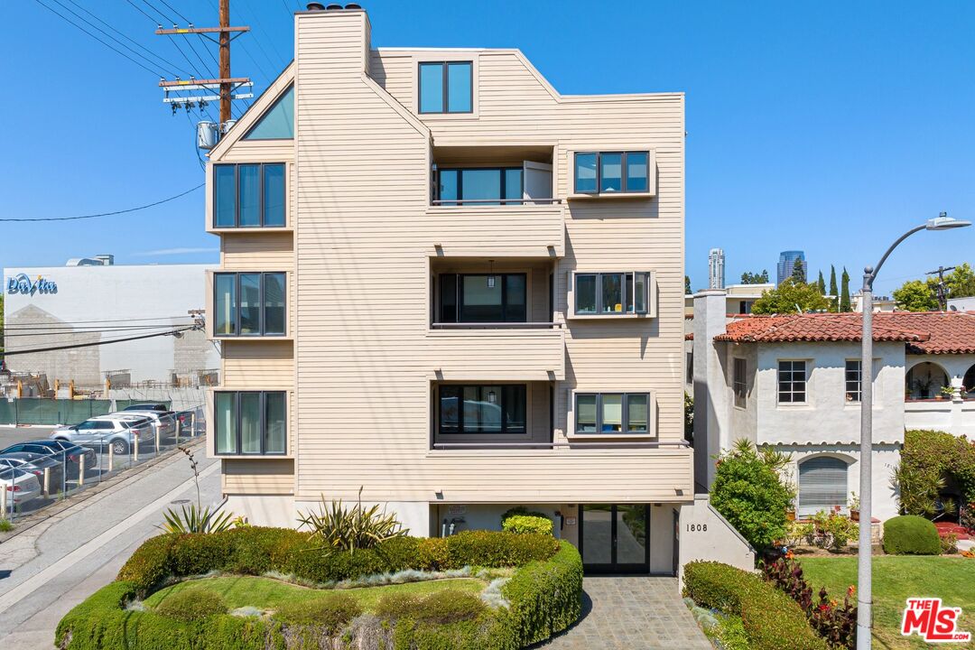 a front view of a residential apartment building with a yard