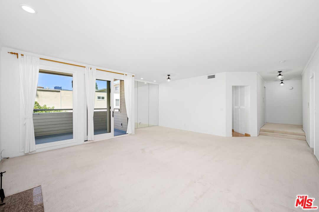 1808 Manning Avenue, Unit 103 Los Angeles, CA 90025 - Photo 4 of 13 an empty room with closet and mirrors