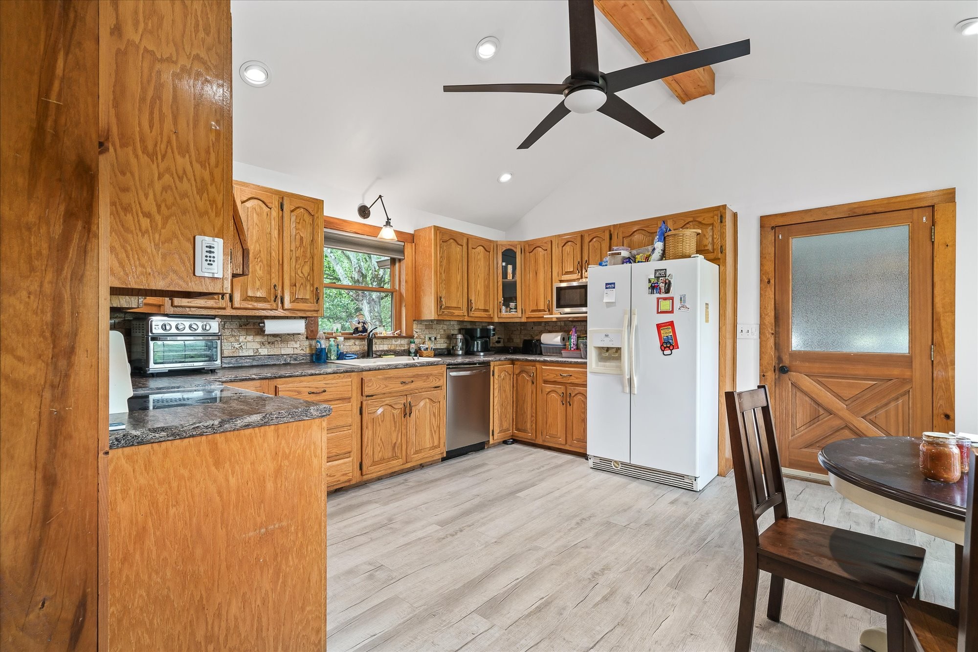 385 Paul Reecer Road Moss, TN 38575 - Photo 35 of 75 a kitchen with granite countertop a refrigerator a sink a stove and white cabinets