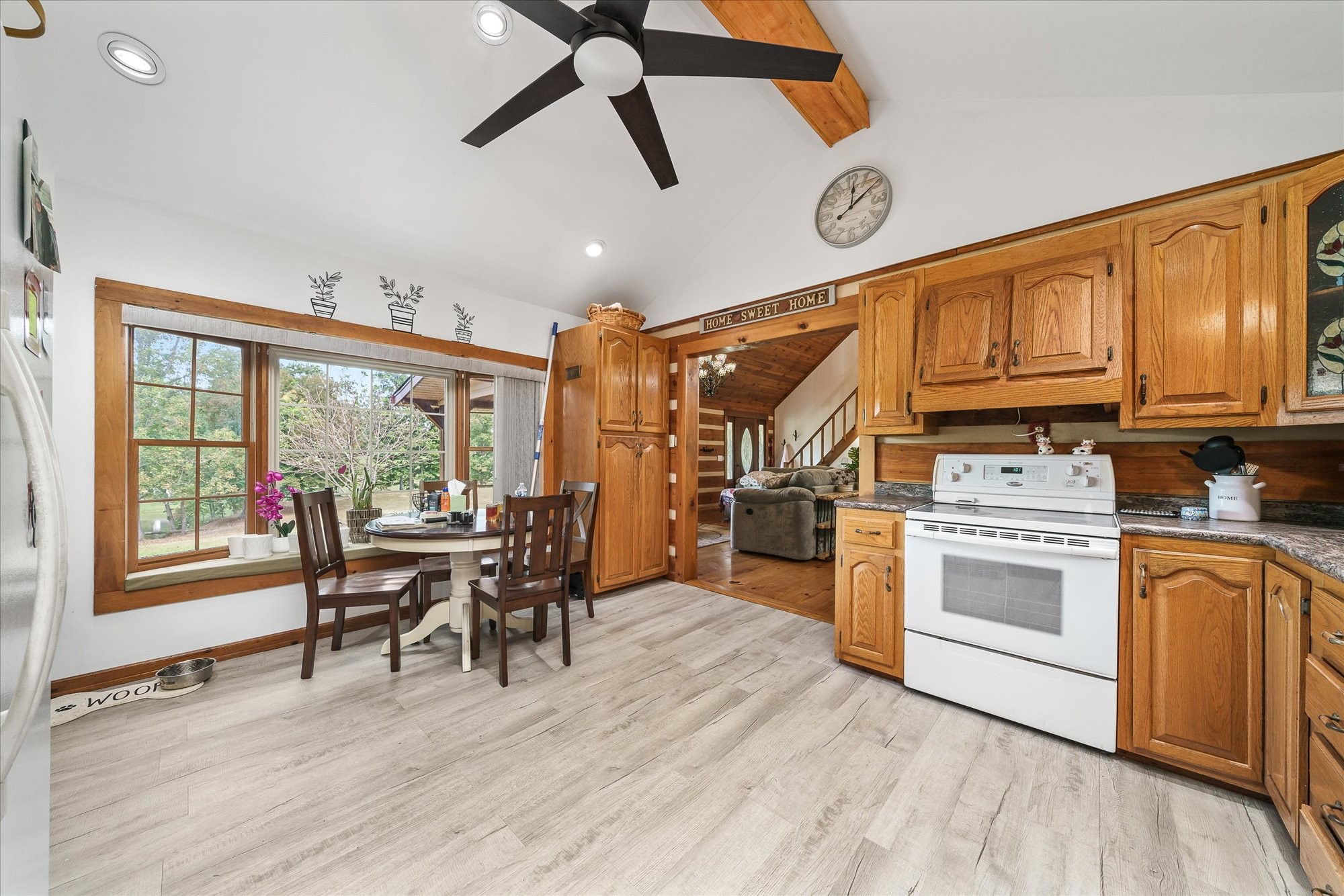 385 Paul Reecer Road Moss, TN 38575 - Photo 38 of 75 a kitchen with stainless steel appliances granite countertop a stove top oven a dining table and chairs with wooden floor