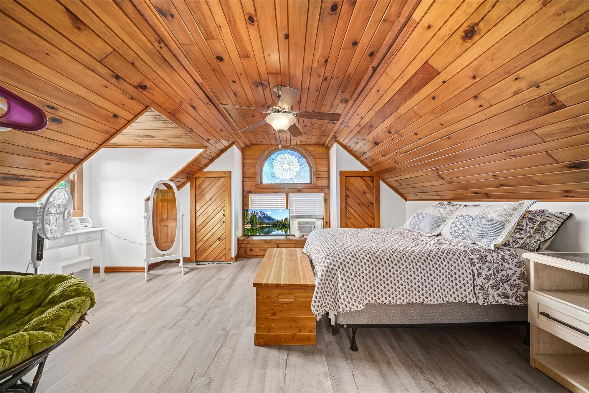 385 Paul Reecer Road Moss, TN 38575 - Photo 52 of 75 a bedroom with a bed a mirror and a large window with wooden floor