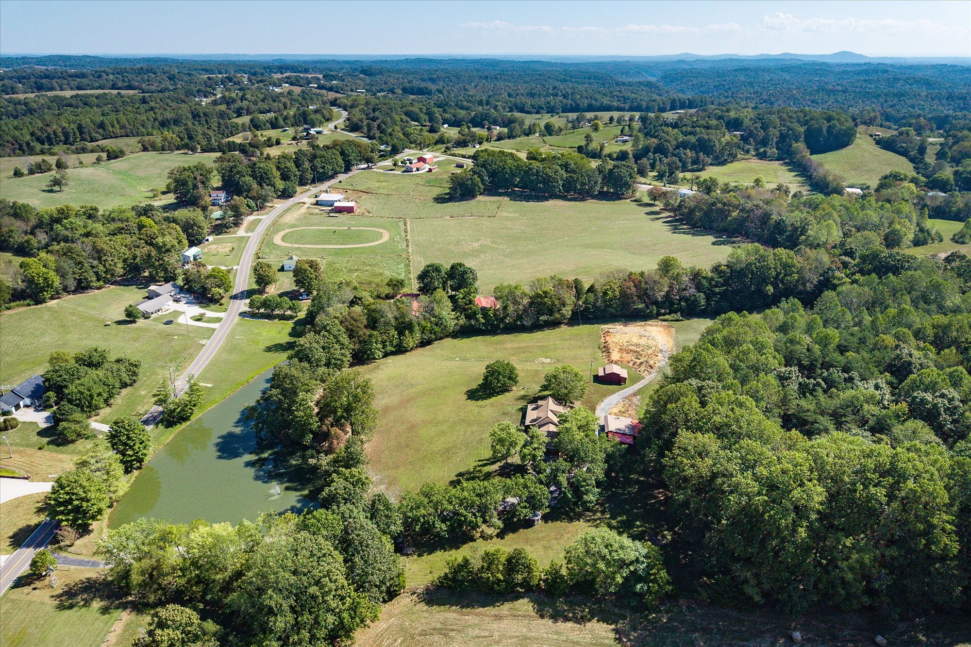385 Paul Reecer Road Moss, TN 38575 - Photo 65 of 75 an aerial view of green landscape with trees houses and lake view