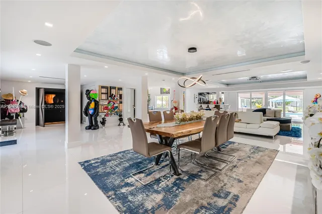 a living room with lots of furniture and view of kitchen