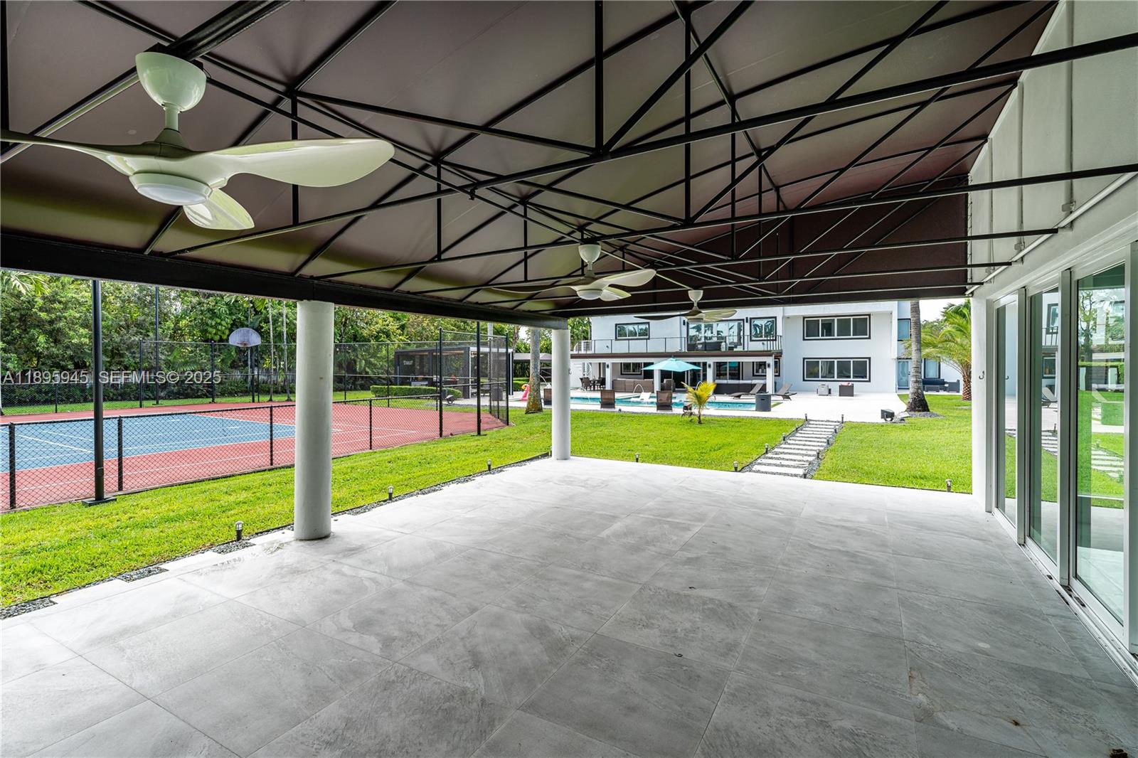 11531 Southwest 93rd Street Miami, FL 33176 - Photo 14 of 54 a view of a house with a big yard and large trees