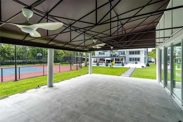 a view of a house with a big yard and large trees