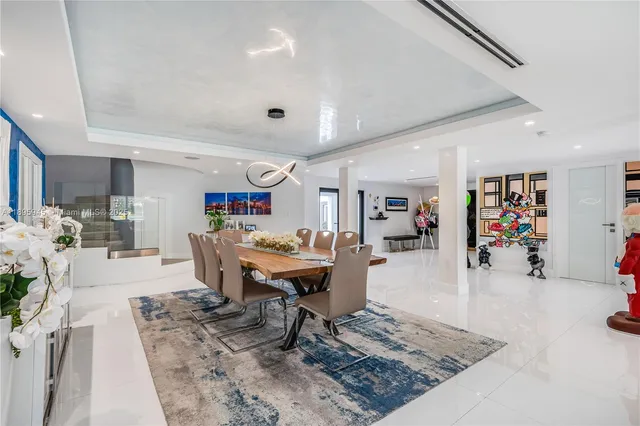 a bedroom with a bed and a dresser with wooden floor