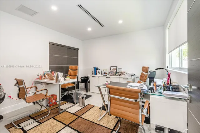 a large white bed sitting in a bedroom next to a window
