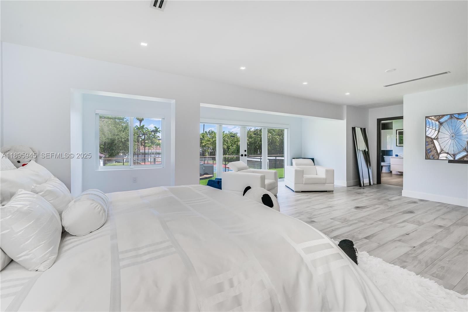 11531 Southwest 93rd Street Miami, FL 33176 - Photo 25 of 54 a large white bed sitting in a bedroom next to a window