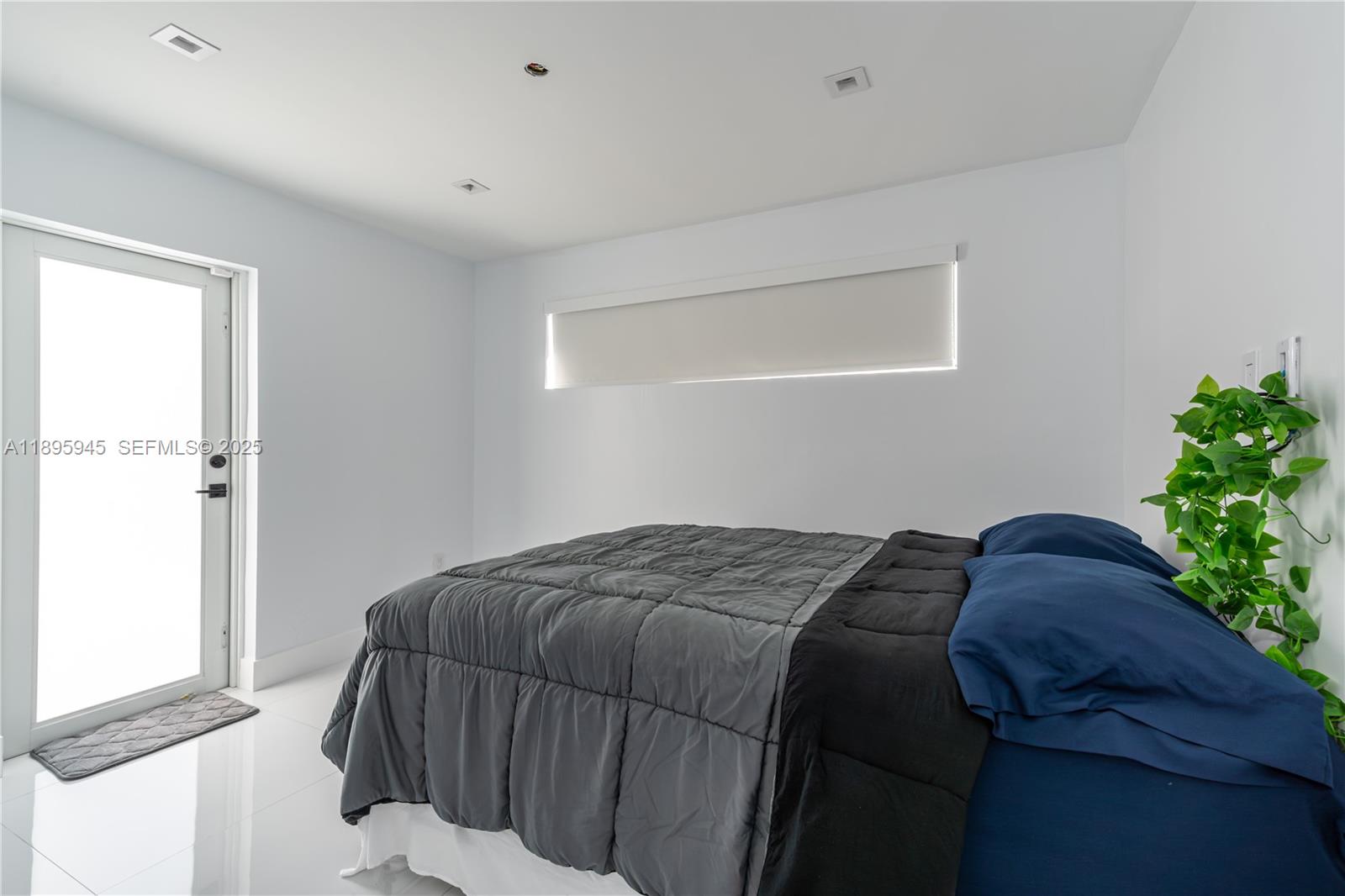 11531 Southwest 93rd Street Miami, FL 33176 - Photo 30 of 54 a bed sitting in a bedroom next to a window