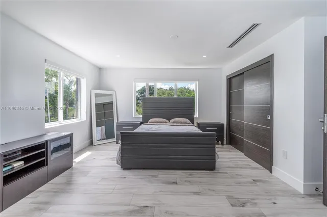 a bathroom with a sink a toilet a mirror and shower