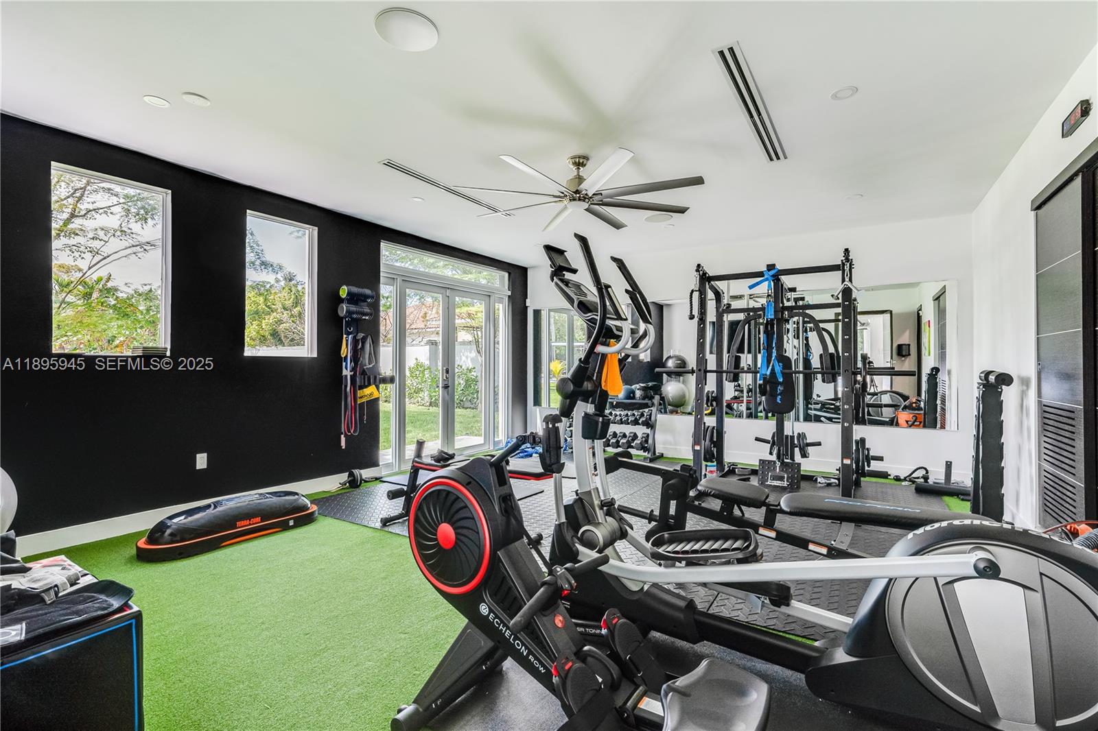 11531 Southwest 93rd Street Miami, FL 33176 - Photo 37 of 54 a room with gym equipment and large mirror