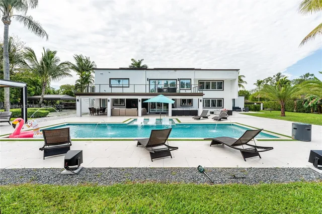 a view of a backyard and floor to ceiling window