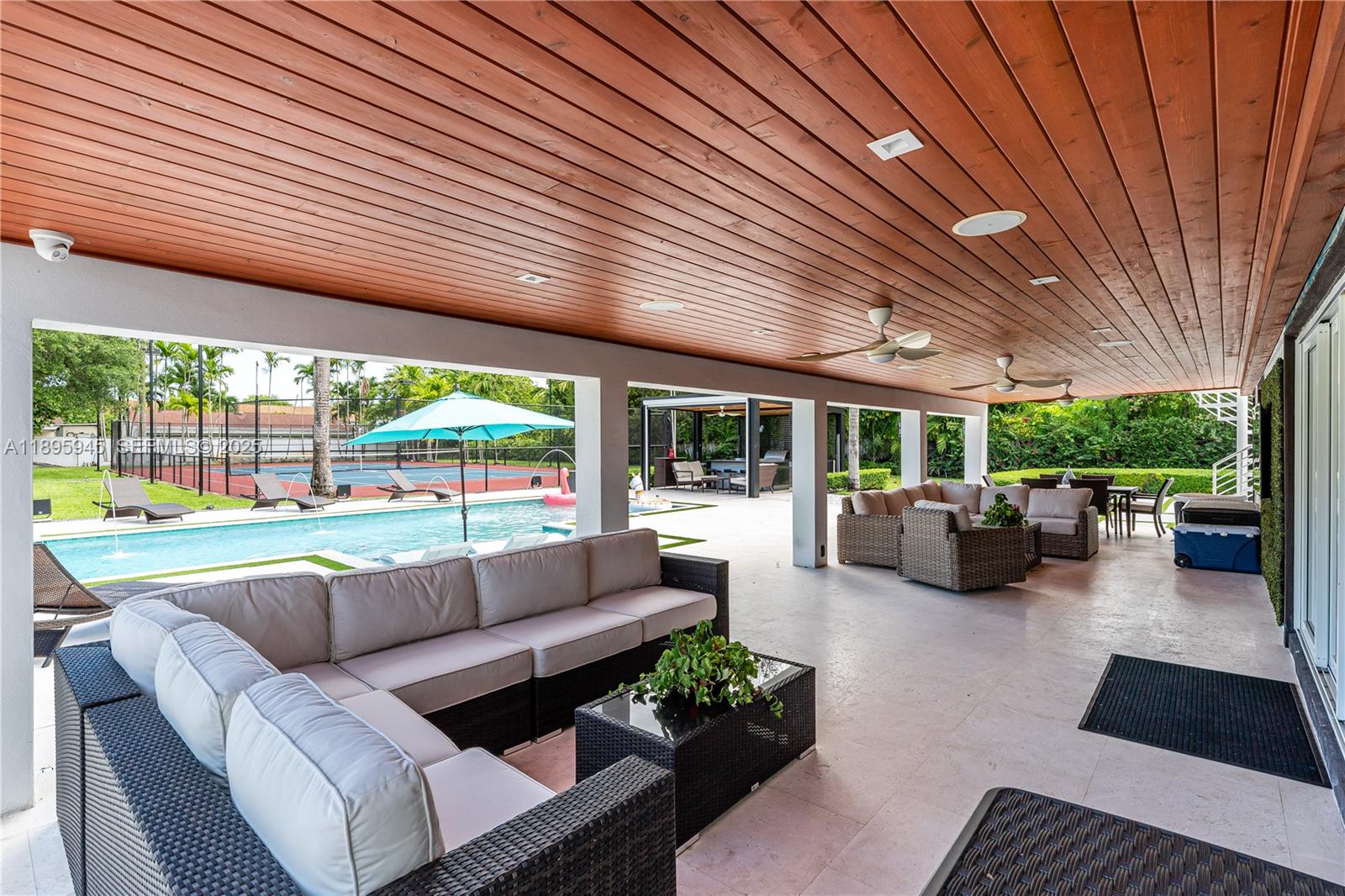 11531 Southwest 93rd Street Miami, FL 33176 - Photo 39 of 54 a living room with patio furniture and a garden