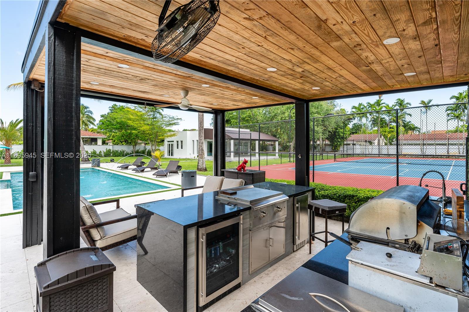 11531 Southwest 93rd Street Miami, FL 33176 - Photo 40 of 54 a view of a patio with table and chairs potted plants with wooden floor and fence