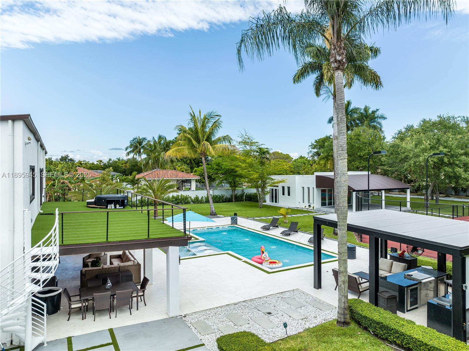 11531 Southwest 93rd Street Miami, FL 33176 - Photo 45 of 54 a view of a swimming pool with a patio and a garden