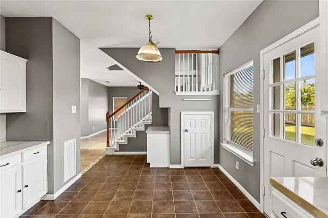 a view of entryway and hall with wooden floor