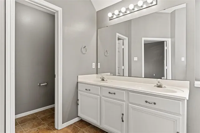 a bathroom with a double vanity sink and mirror
