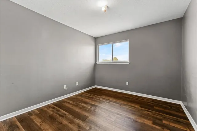 a view of room with window and hardwood floor