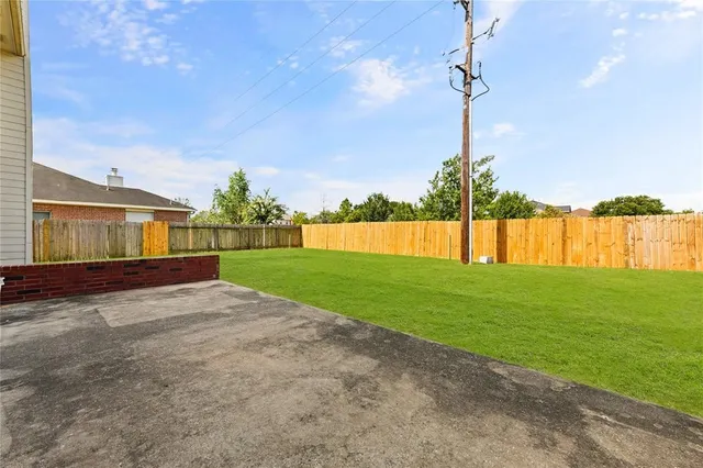 a view of a house with a backyard