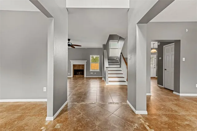 wooden floor in a hall with an entryway and livingroom view