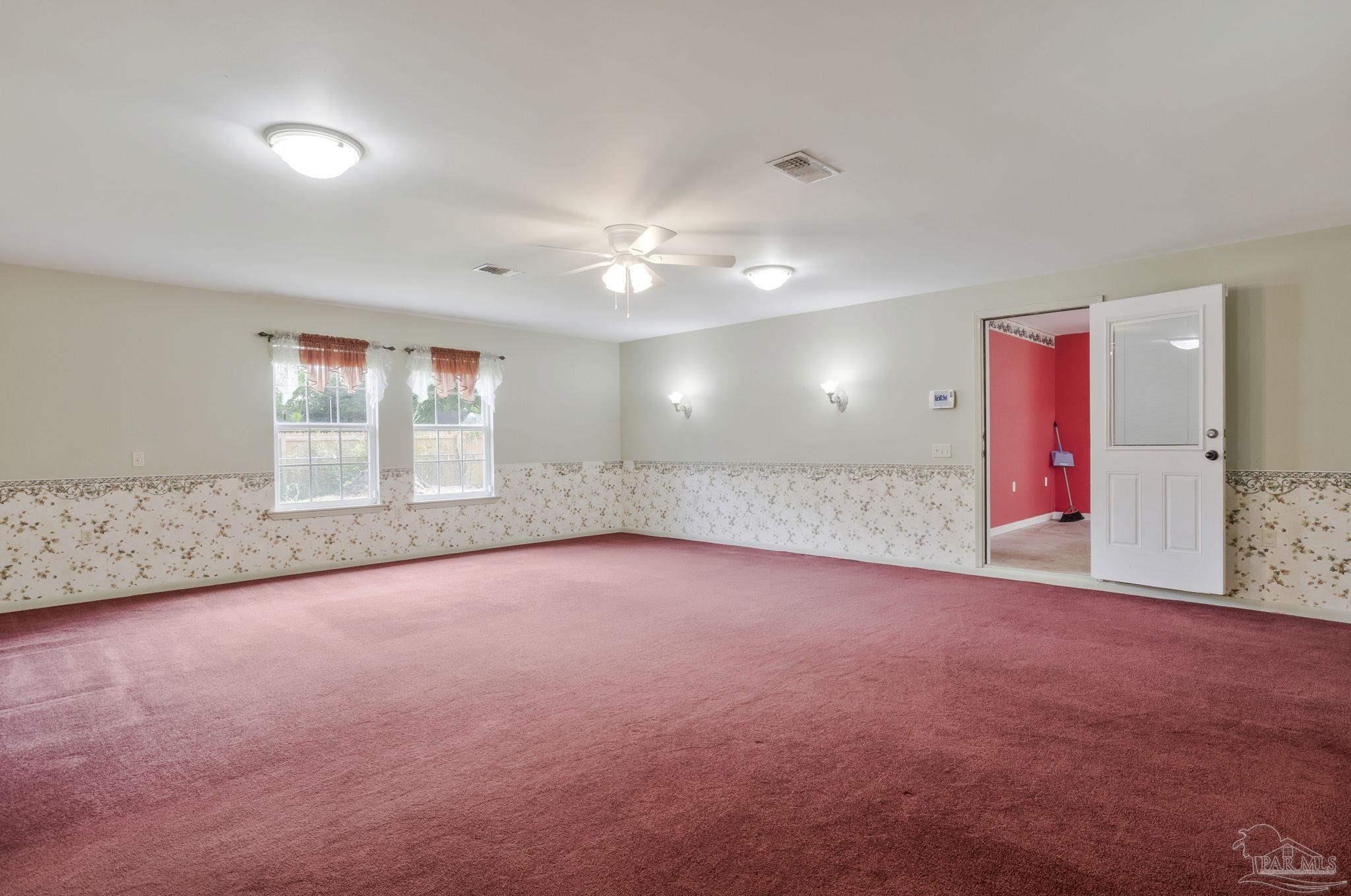 4411 Pace Lane Pace, FL 32571 - Photo 18 of 68 an empty room with windows and ceiling fan