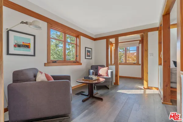 a living room with furniture a flat screen tv and a window