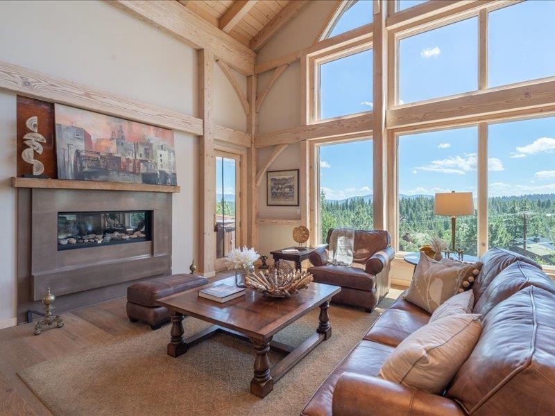 12386 Stockholm Way Truckee, CA 96161 - Photo 5 of 21 a living room with furniture large window and a fireplace