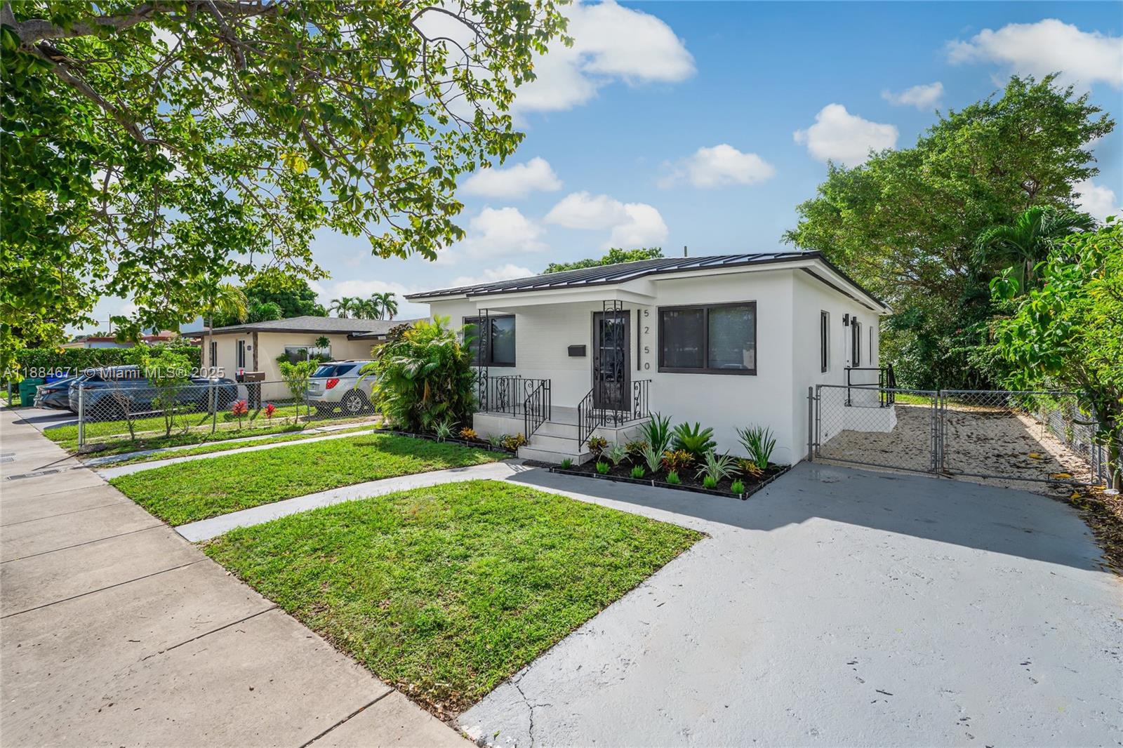5250 Northwest 4th Street Miami, FL 33126 - Photo 1 of 41 a front view of house with yard and green space