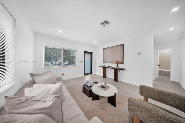 a living room with furniture and a table