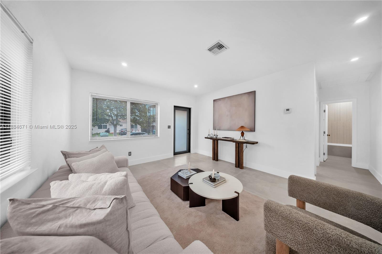 5250 Northwest 4th Street Miami, FL 33126 - Photo 11 of 41 a living room with furniture and a table