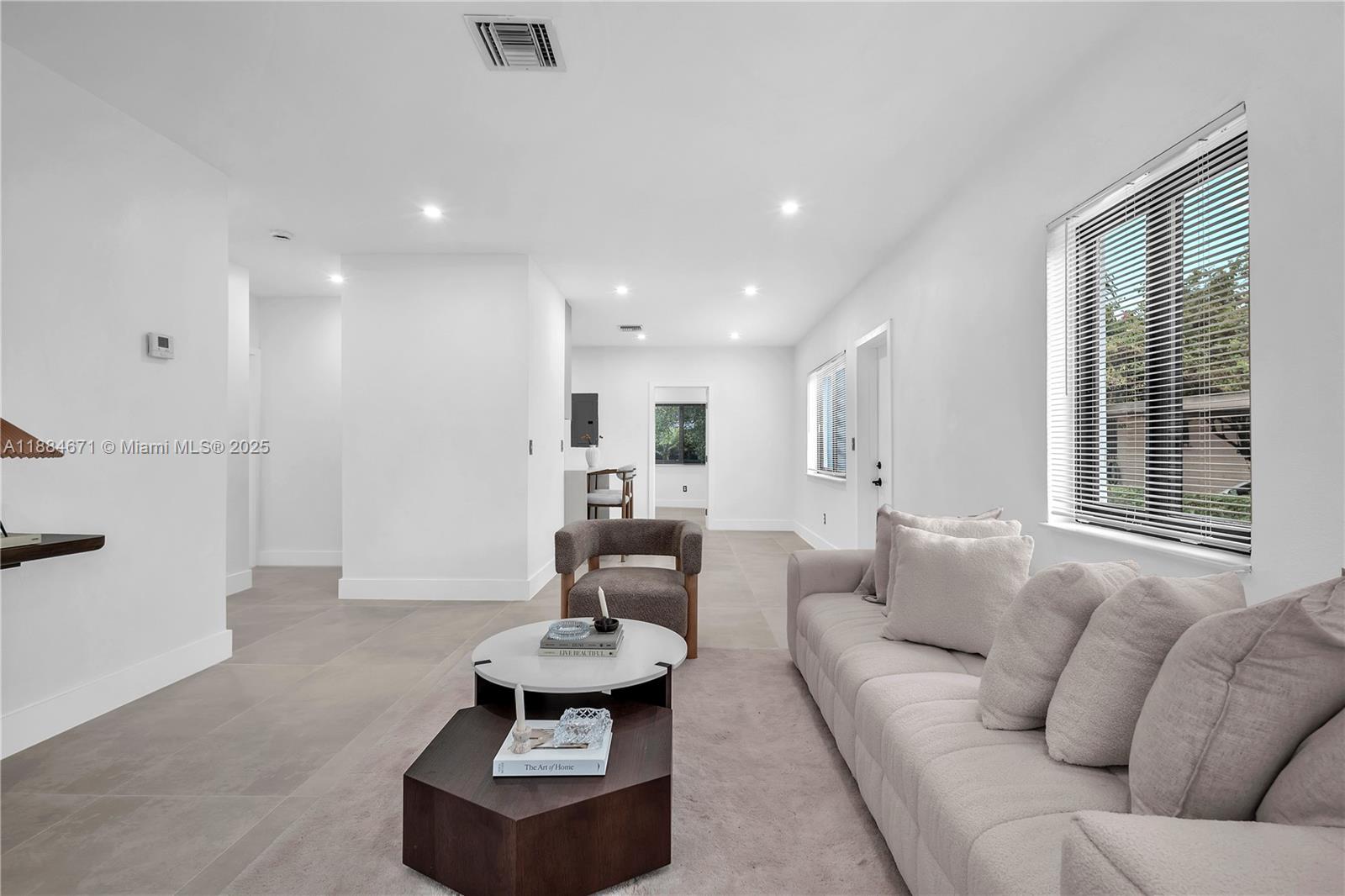 5250 Northwest 4th Street Miami, FL 33126 - Photo 12 of 41 a living room with furniture and a large window