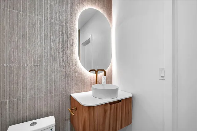 a bathroom with a sink a mirror and vanity