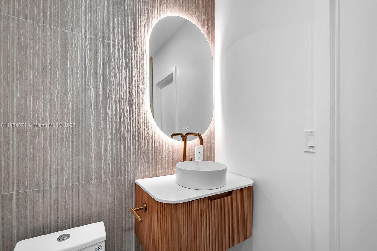 5250 Northwest 4th Street Miami, FL 33126 - Photo 21 of 41 a bathroom with a sink a mirror and vanity