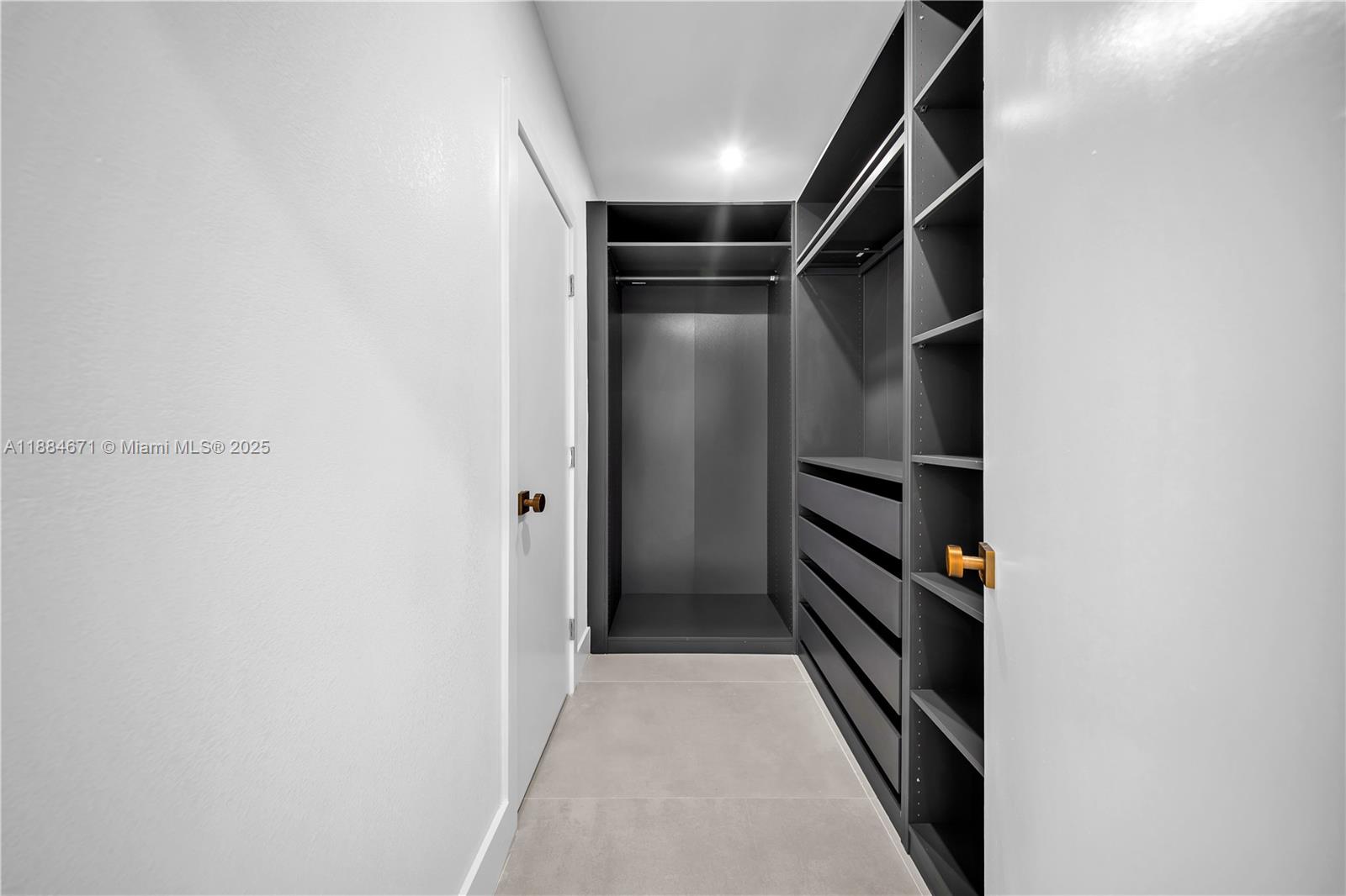 5250 Northwest 4th Street Miami, FL 33126 - Photo 23 of 41 a view of walk in closet with empty racks