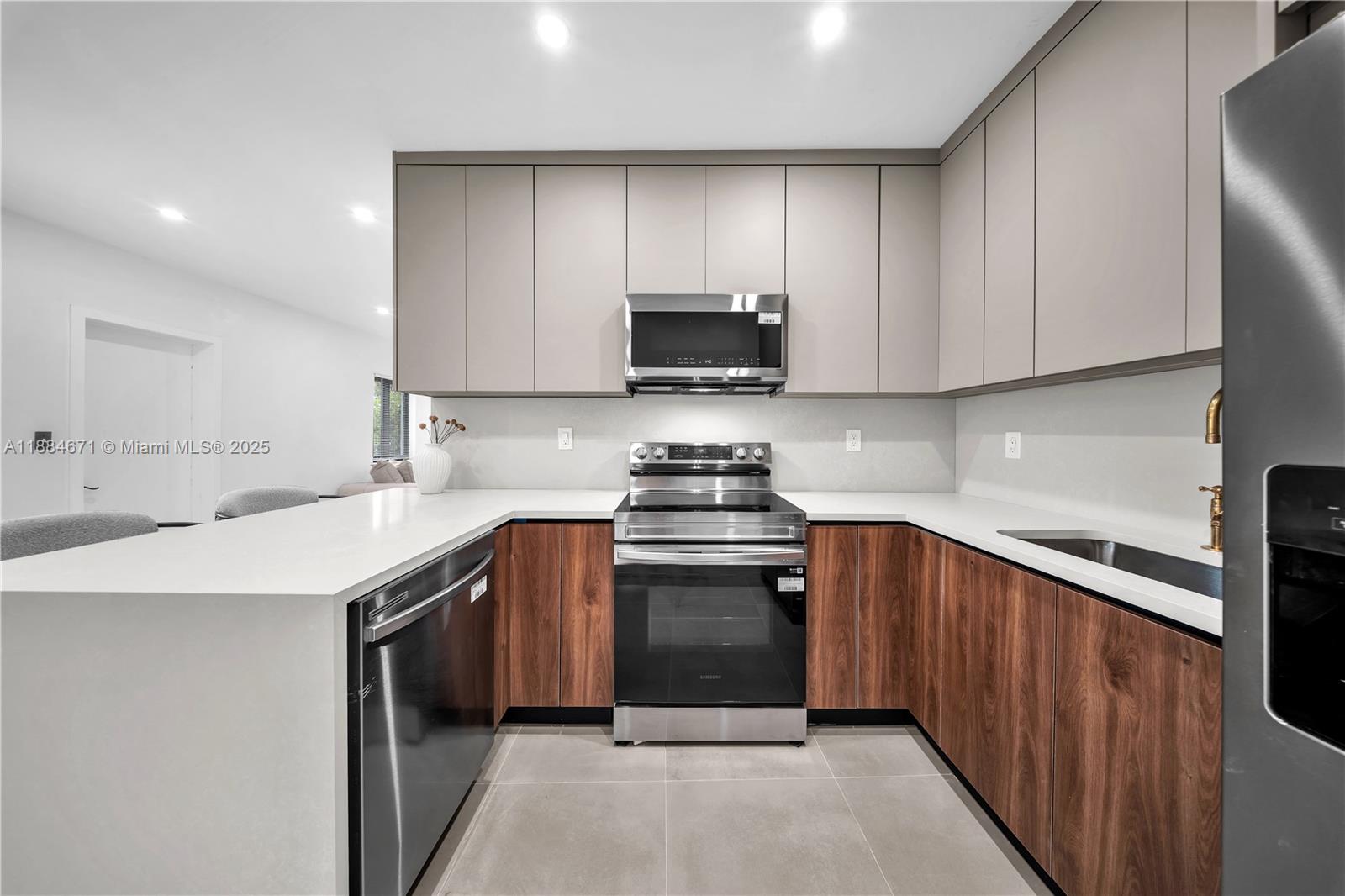 5250 Northwest 4th Street Miami, FL 33126 - Photo 5 of 41 a kitchen with stainless steel appliances granite countertop a stove a sink and a microwave