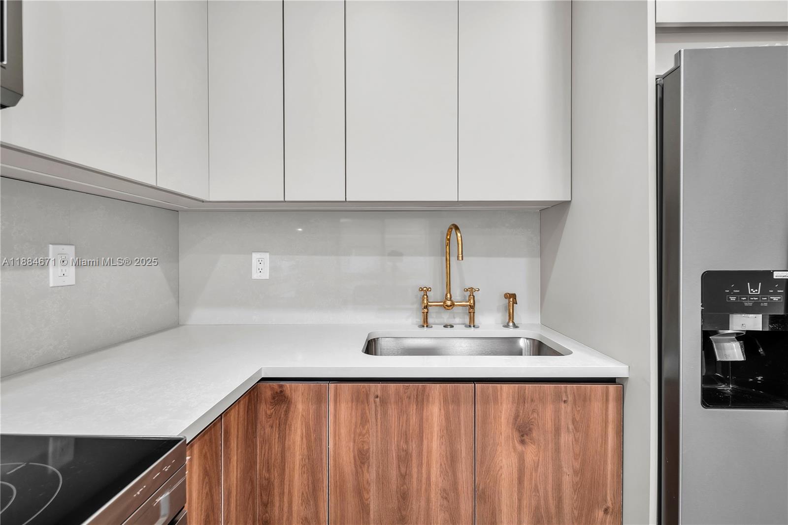 5250 Northwest 4th Street Miami, FL 33126 - Photo 6 of 41 a kitchen with white cabinets and sink