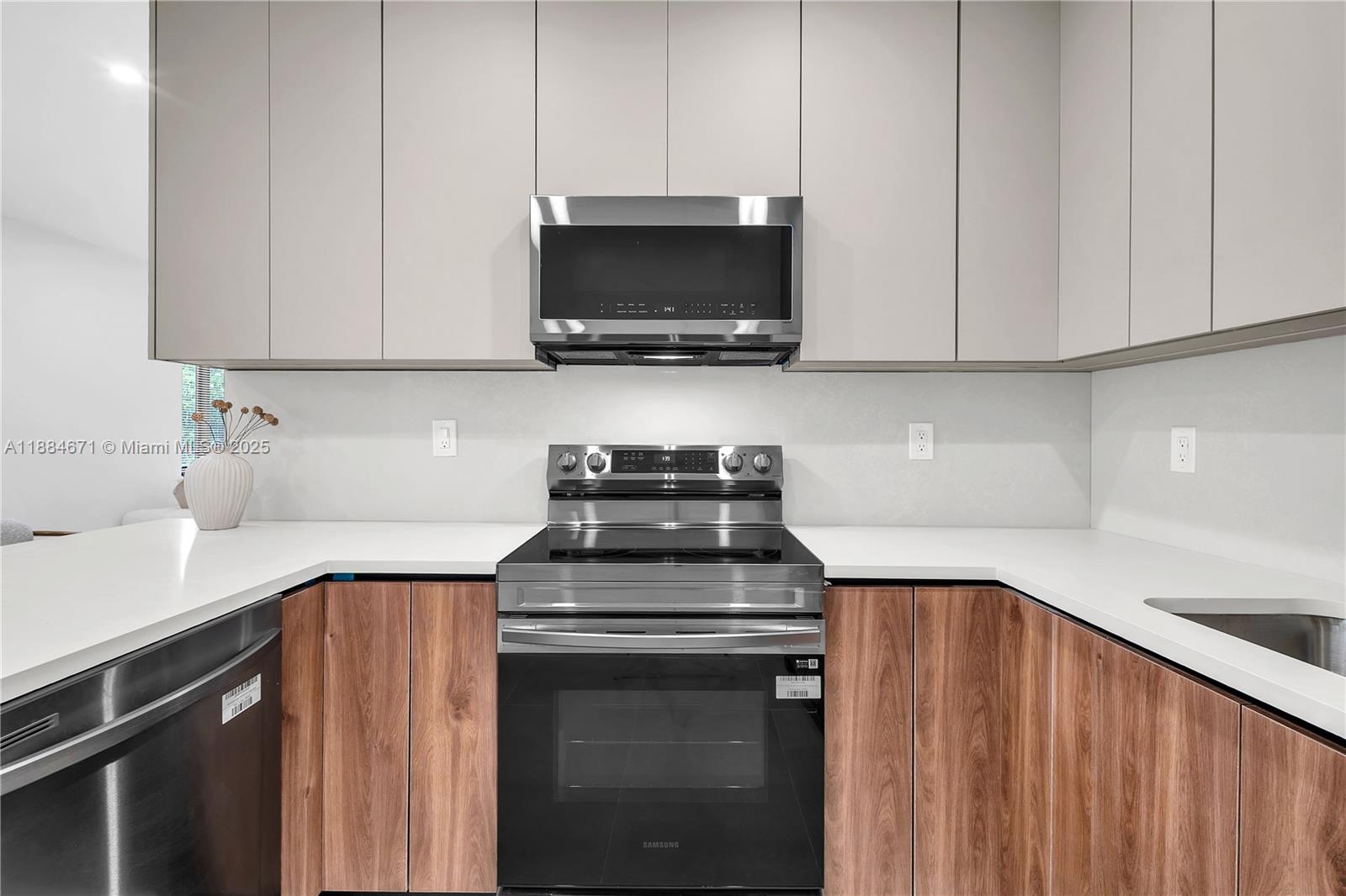 5250 Northwest 4th Street Miami, FL 33126 - Photo 7 of 41 a kitchen with a stove and a microwave