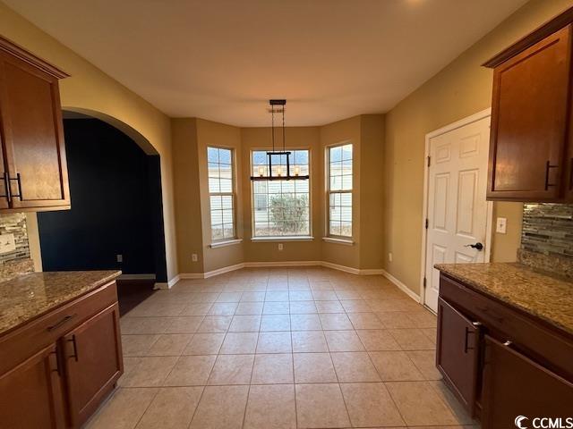 237 Golden Oaks Drive Murrells Inlet, SC 29576 - Photo 17 of 21 Unfurnished dining area featuring arched walkways and light tile patterned floors