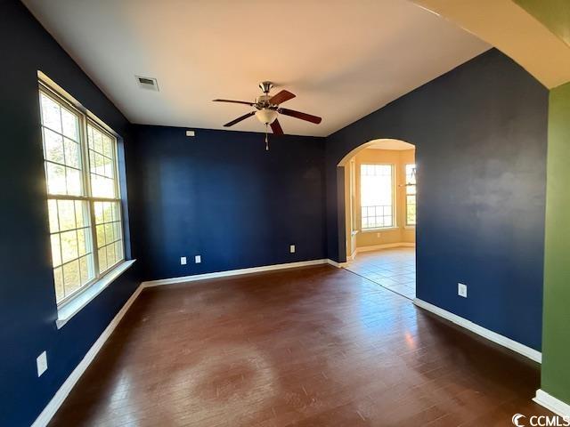 237 Golden Oaks Drive Murrells Inlet, SC 29576 - Photo 19 of 21 Unfurnished room with ceiling fan, arched walkways, and dark wood finished floors