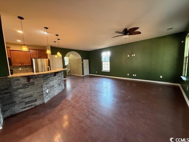 237 Golden Oaks Drive Murrells Inlet, SC 29576 - Photo 20 of 21 Unfurnished living room featuring arched walkways, ceiling fan, dark wood-style floors, and recessed lighting
