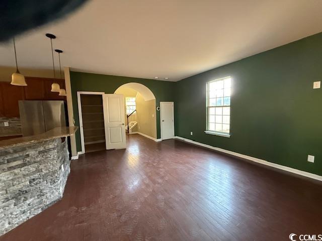 237 Golden Oaks Drive Murrells Inlet, SC 29576 - Photo 5 of 21 Unfurnished living room featuring arched walkways and dark wood-style flooring