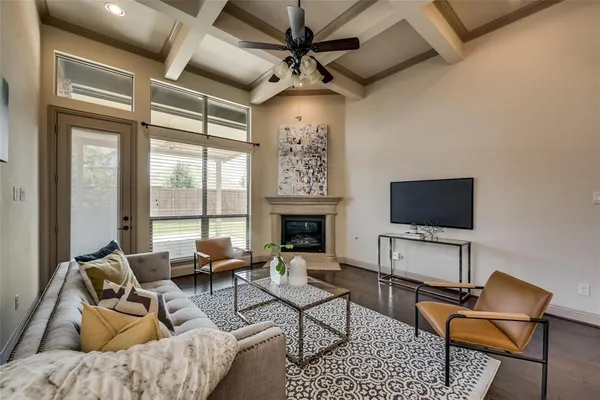 a living room with furniture and a chandelier