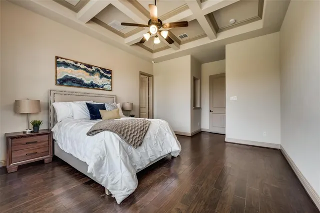 a spacious bedroom with a bed and a large window with wooden floor