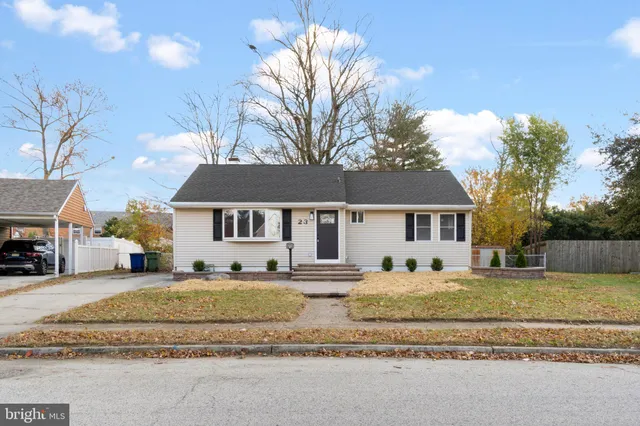 a house that has a tree in front of it