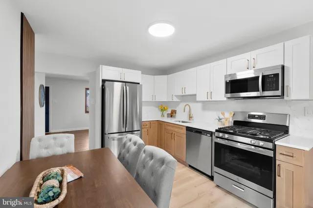 a kitchen with stainless steel appliances granite countertop a stove a refrigerator and a microwave